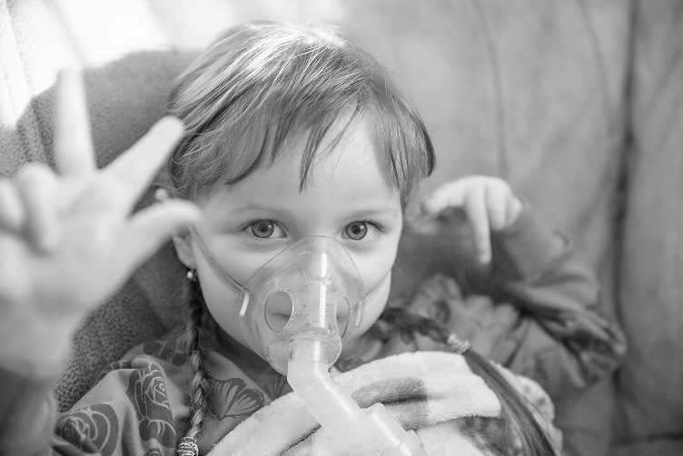 young girl wearing nebulizer