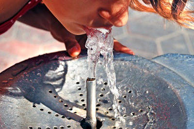 Person drinking from a water fountain