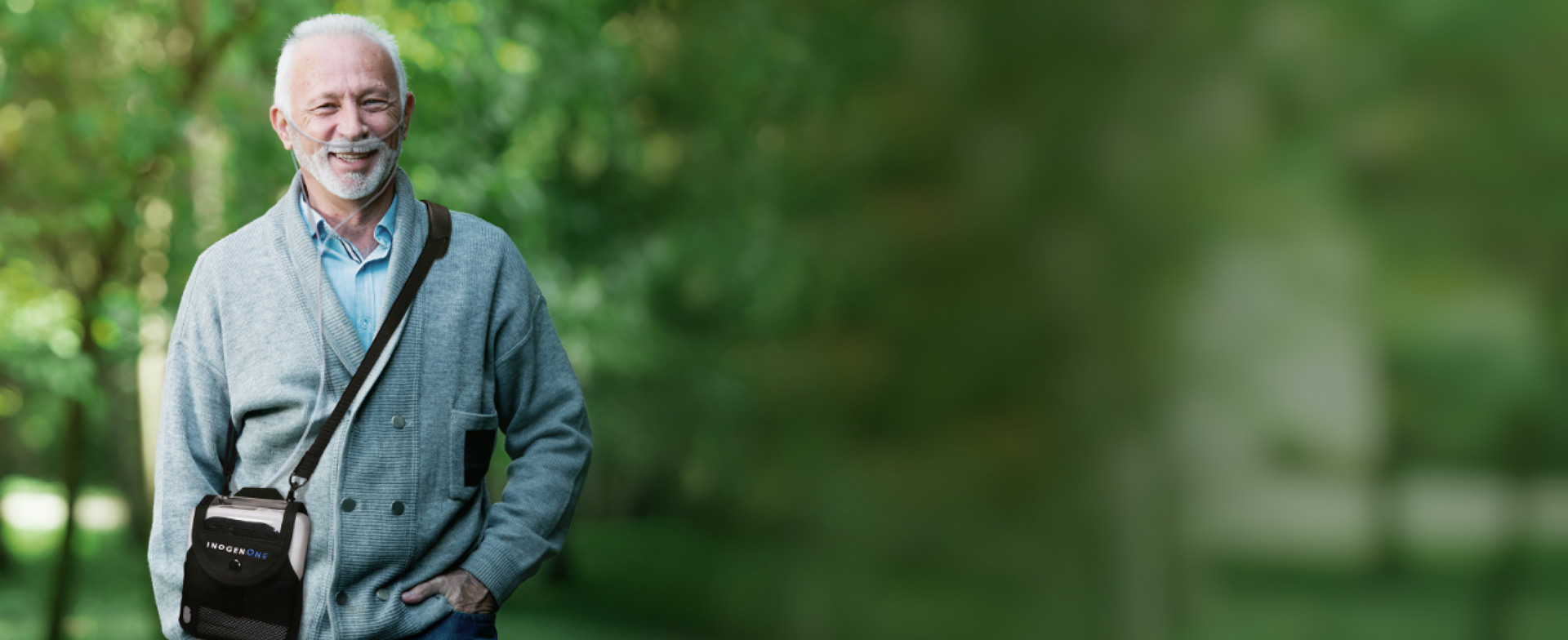 Woman and dog on a park bench with an Inogen Portable Oxygen Concentrator